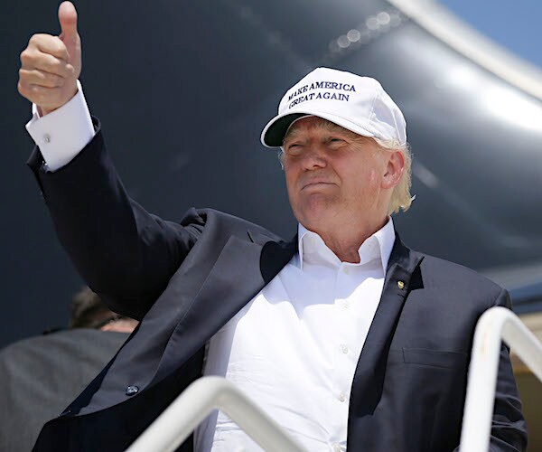 president donald trump gives thumbs up as he departs air force one