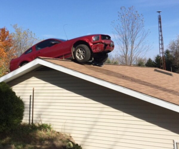 Car on Roof: Mustang Loses Control on Highway, Ends Up on Top of House