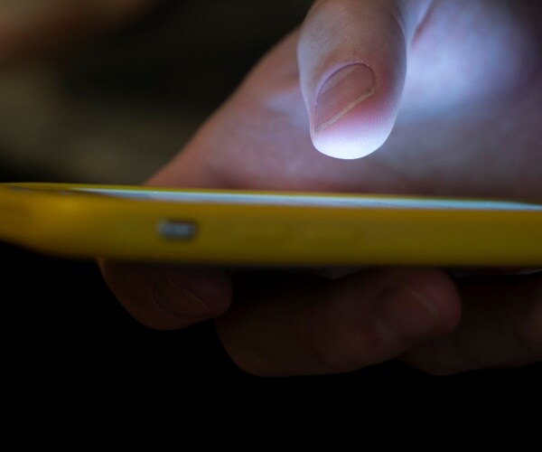 A man uses a cell phone in New Orleans.