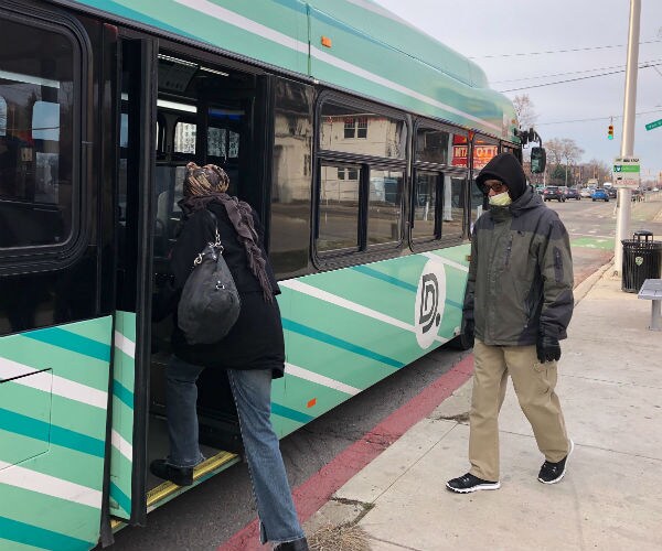 bus riders in detroit enter through the rear of the vehicle 