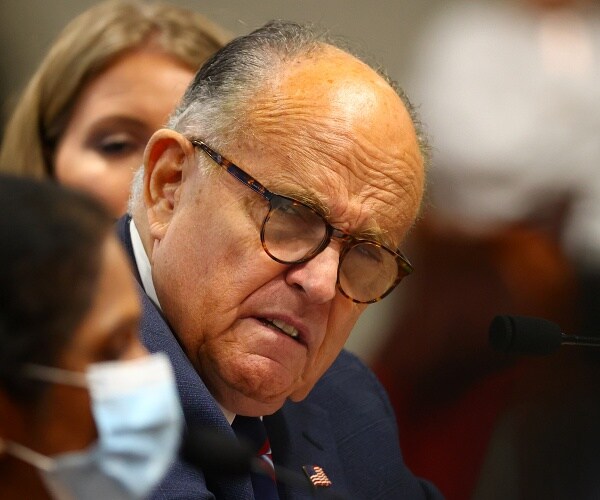 rudy giuliani listens to poll worker 