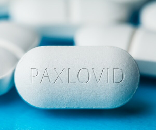 close-up of big white pill with 'Paxlovid' on it