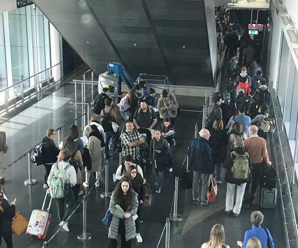 US Airports Overwhelmed as Virus Restrictions Take Hold