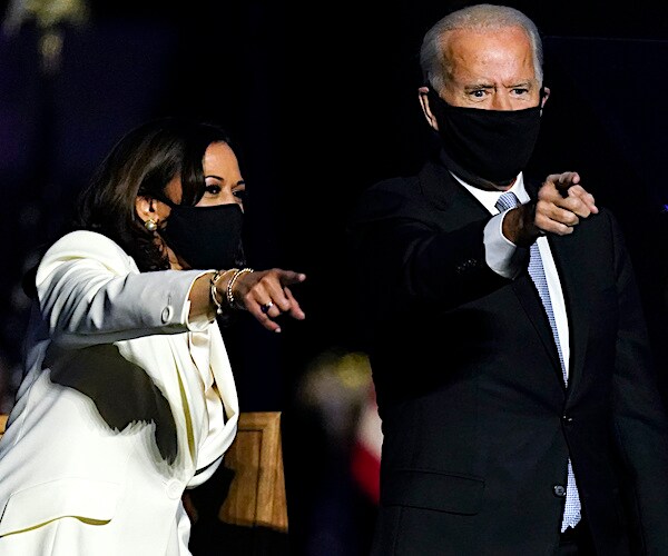 kamala harris and joe biden point after declaring victory after the presidential election