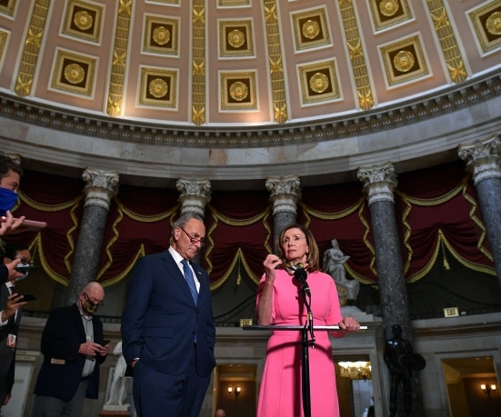 House Speaker Nancy Pelosi, speaks to the media, flanked by US Senate Minority Leader Chuck Schumer,