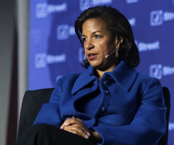 susan rice is shown in a cobalt blue dress speaking 