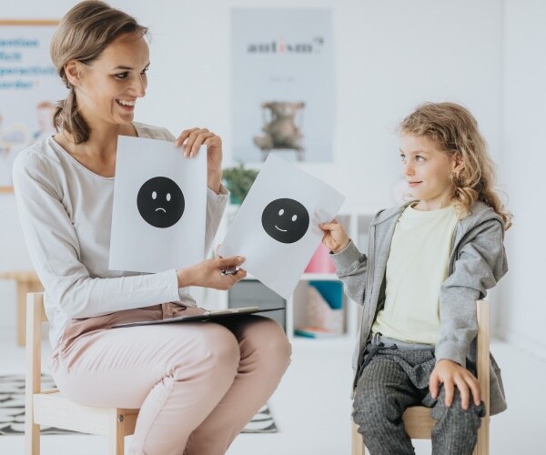 psychologist in classroom with young student