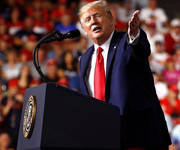 president donald trump gestures while speaking to a large manchester new hampshire campaign rally crowd