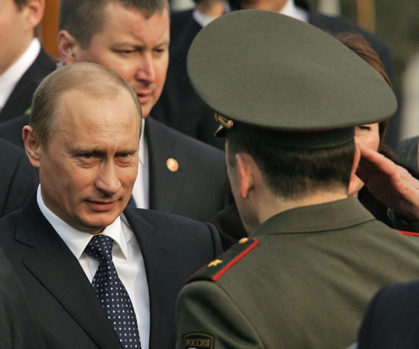 a russian military officer salutes russian president vladimir putin 