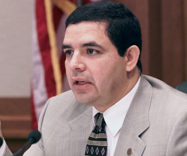 rep. henry cuellar speaking on capitol hill, wearing a tan suit