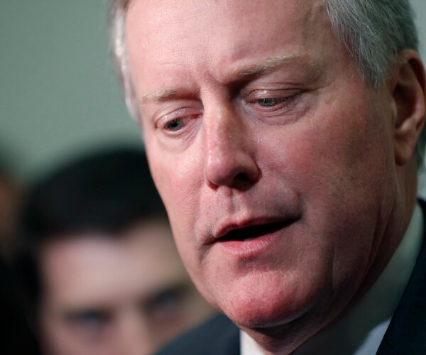 mark meadows looks down during a media scrum