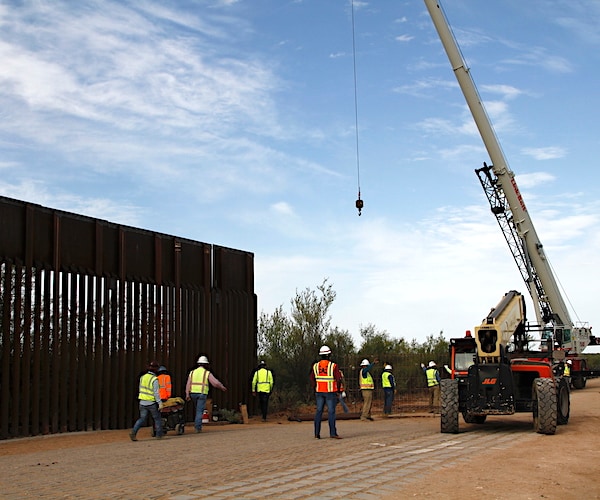 construction workers help build the border wall in southwest texas