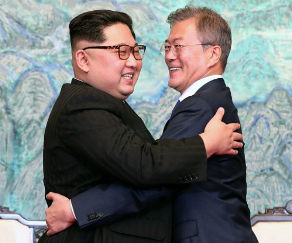 With Hug and Handshakes, North Korea's Smiling Kim Lightens Summit Mood