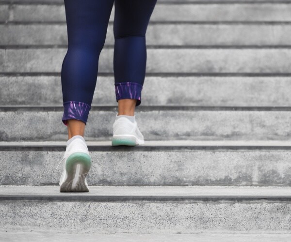 woman running up stairs