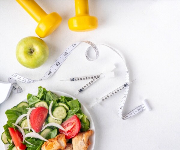 syringes, measuring tape, apple, salad