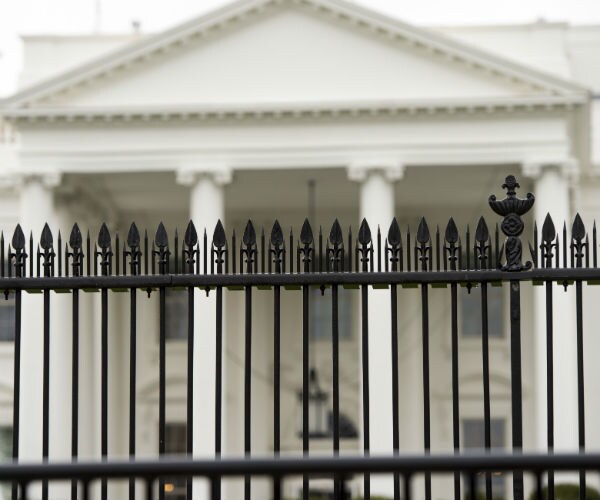 the white house seen behind the white house fence