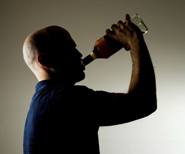 graphic showns a man drink alcohol from a bottle