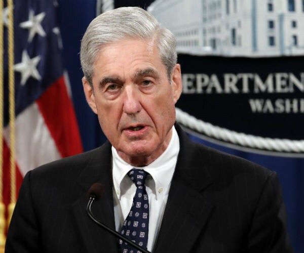 robert mueller is shown with the american flag draped in the background