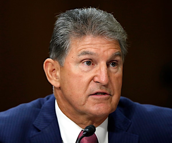 joe manchin listens intently during a senate committee hearing