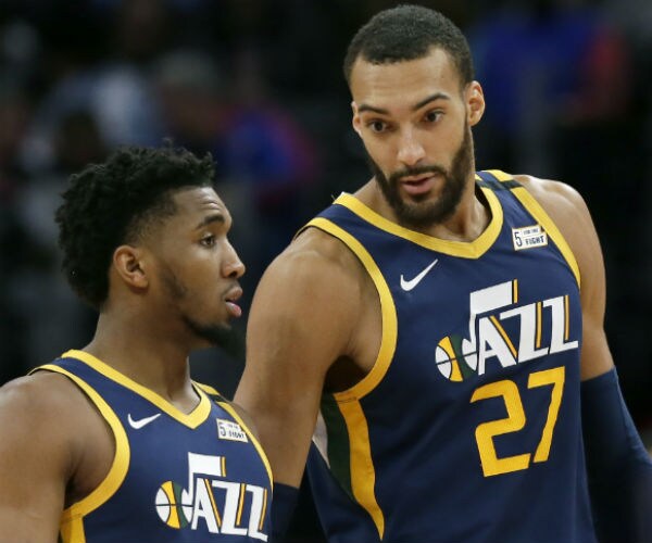 rudy gobert (27) talks with guard donovan mitchell, left, during the second half of an nba basketball game