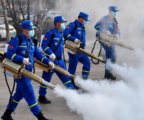 volunteers spray disinfectant