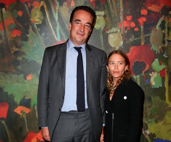 mary kate olsen in a black dress and sarkozy in a gray suit blue shirt and black tie