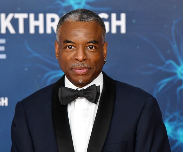 levar burton stands on red carpet