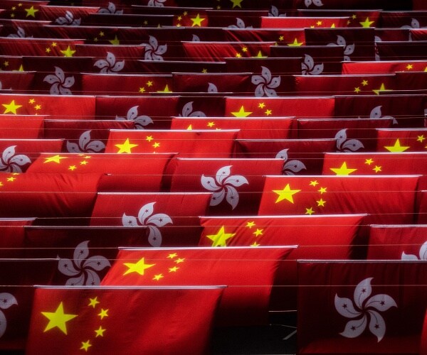 china and hong kong flags hang over street