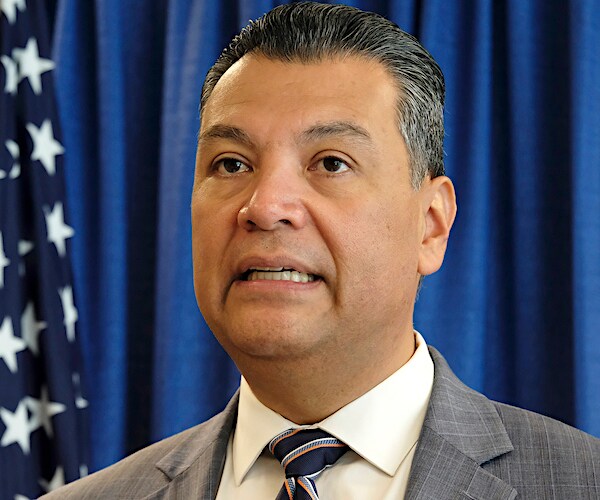 California Secretary of State Alex Padilla speaks during a news conference with an american flag to his right