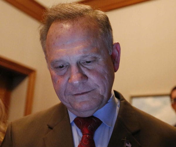 roy moore looks down at a monitor to check out election returns on the day he was defeated