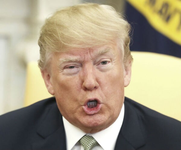 donald trump speaks while sitting in the oval office sitting area