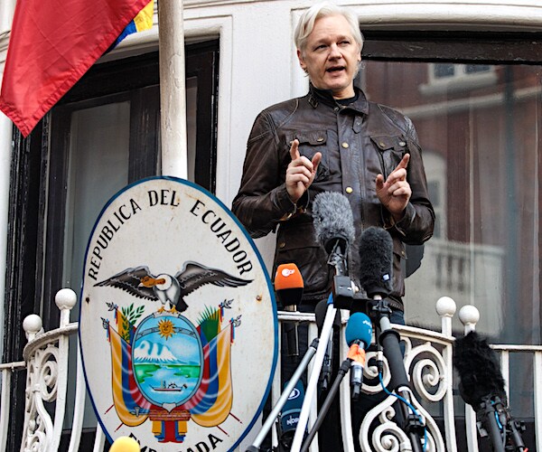 julian assange addresses the public from an embassy in london