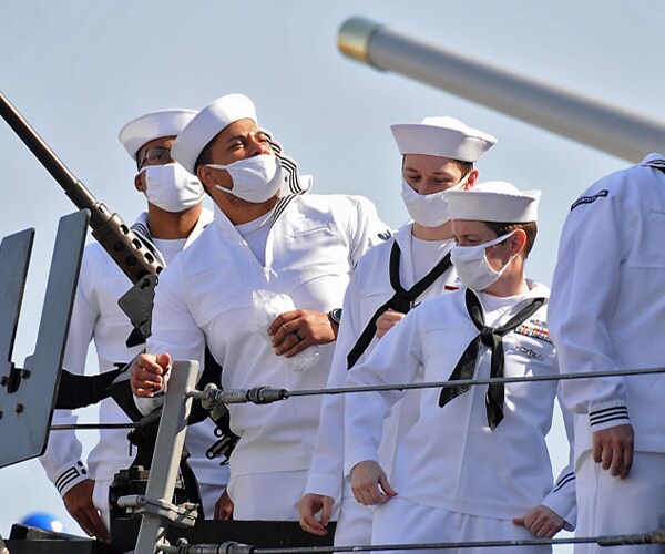 us sailors stand aboard the uss winston s churchill in port sudan in 2021
