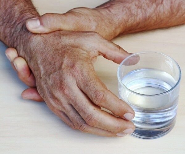 hand tremor, trying to hold water glass