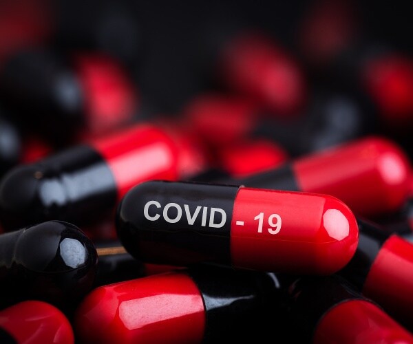 red and black capsules, one says 'COVID-19'