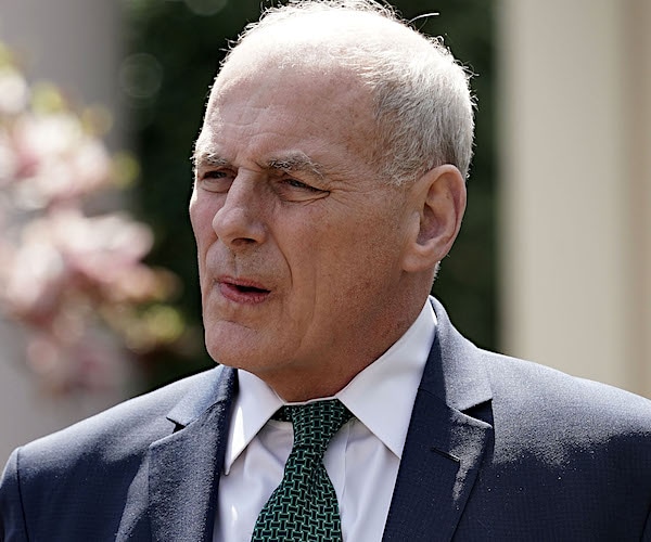 retired general john kelly walks out of the white house on a bright sunny day