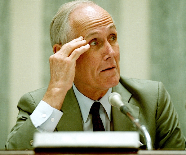 slade gorton scratches his forehead during a congressional hearing when he was a part of the senate