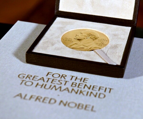 nobel prize medal sits on table in box