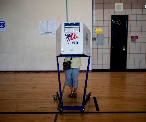 woman votes at a polling site in NY