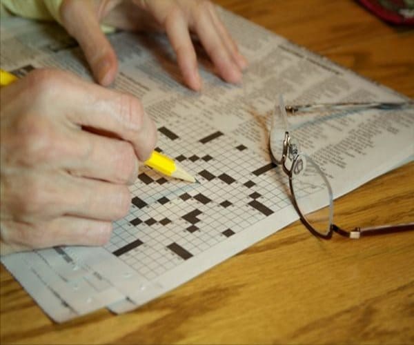 a person working on a crossword puzzle