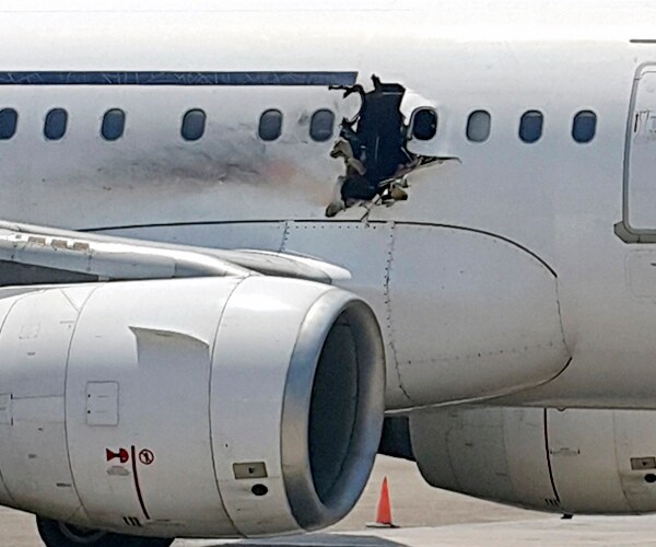 Somali Airport Workers Passing Passenger a Bomb Seen on Video