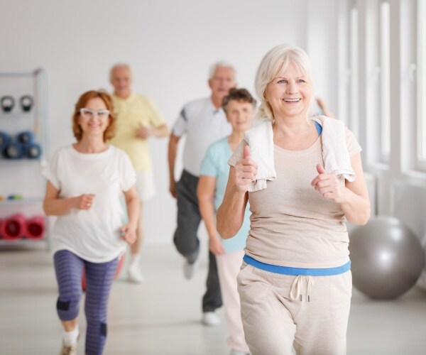 seniors smiling while exercising together