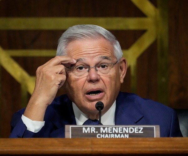 bob menendez speaks into mic