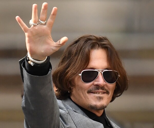 johnny depp gestures as he leaves the high court