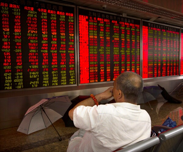 A Chinese investor monitors stock prices in Beijing