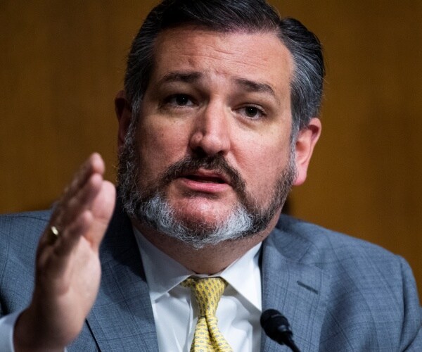 cruz in a gray suit and yellow tie