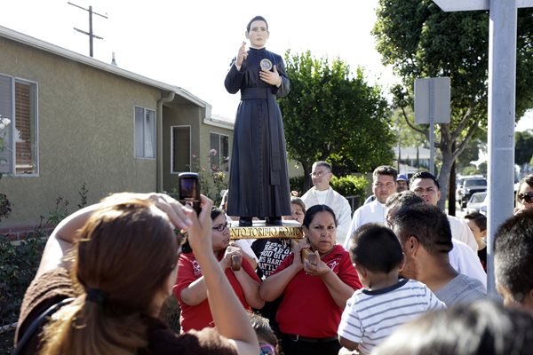 Immigrants Flock to See Statue of Beloved Saint