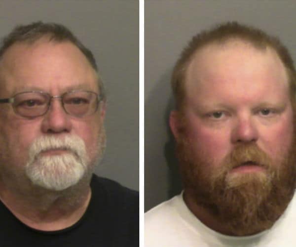 gregory, on left, and travis mcmichaels are shown in jail mug shots.