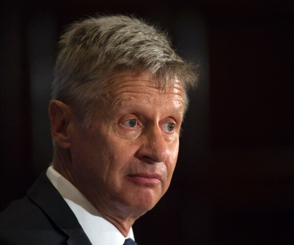 gary johnson in a suit speaks at a luncheon in d.c.