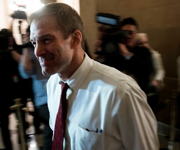 ohio republican representative jim jordan walks through the capitol building amid a throng of reporters